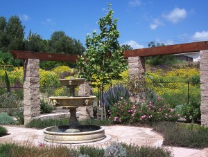 A three-tiered fountain decorates the backyard