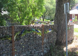empty glass bottles and pebbles make interesting diy fence