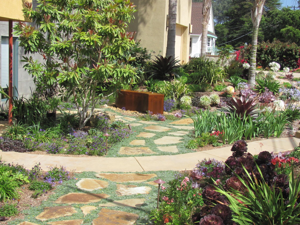 A flagstone path bisects the front garden
