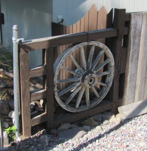 A wagon wheel makes a decorative fence element